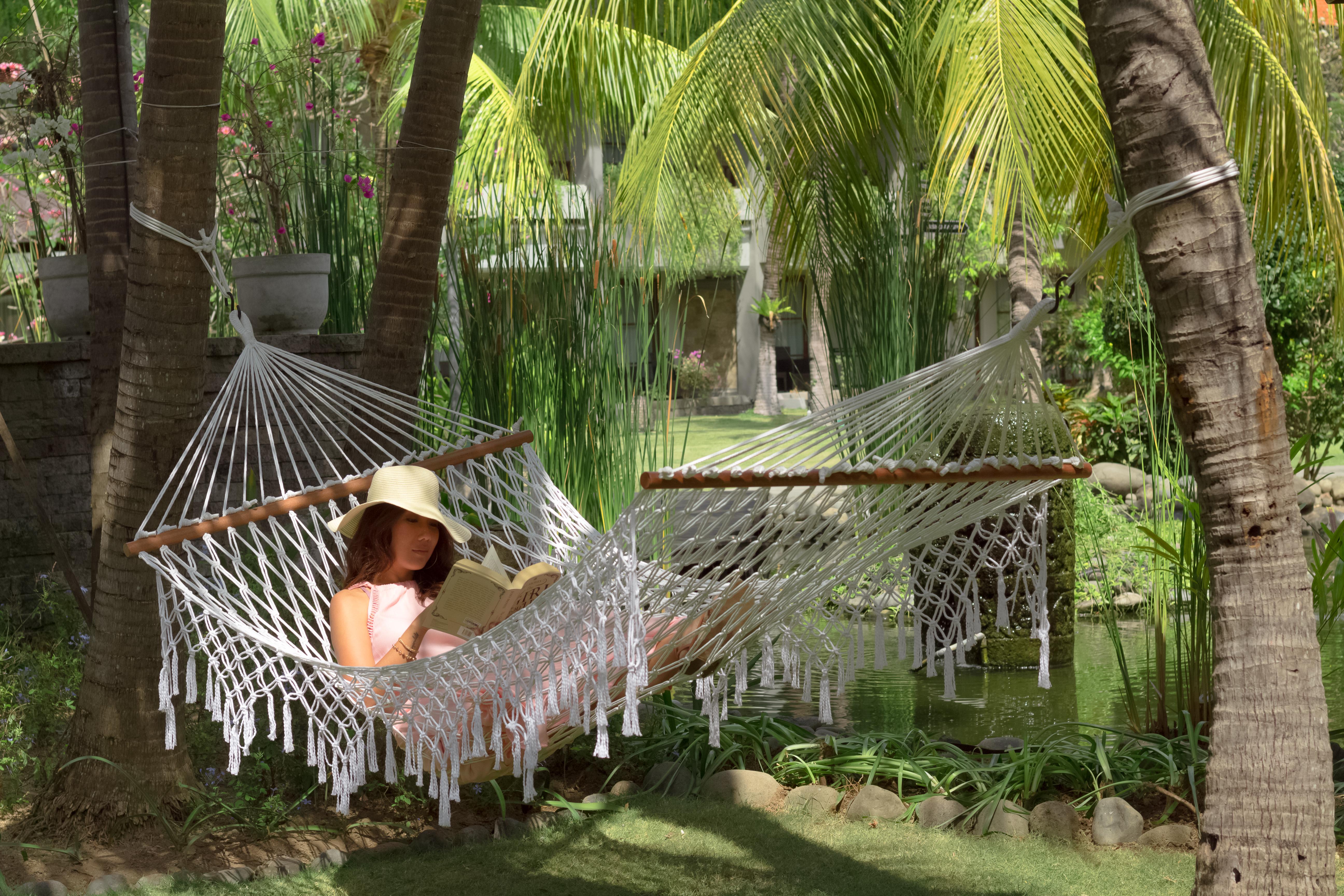 Bali Dynasty Resort Kuta Lombok Εξωτερικό φωτογραφία A woman relaxing in a hammock